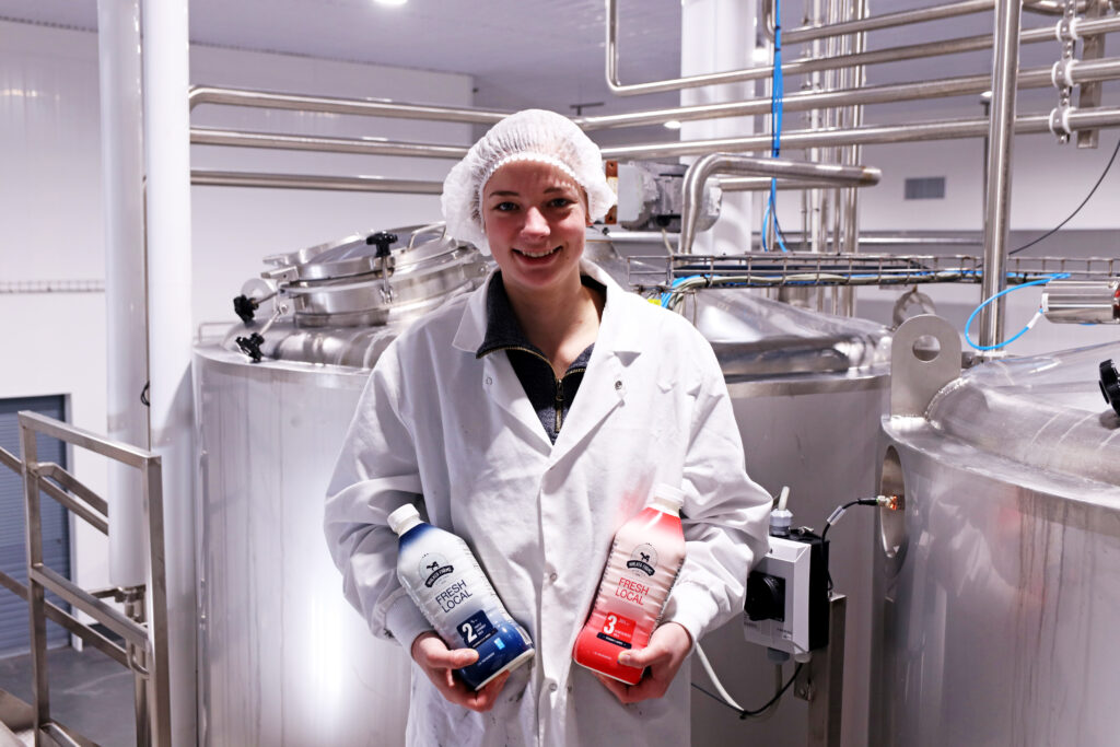 woman holding walker farms milk at the plant